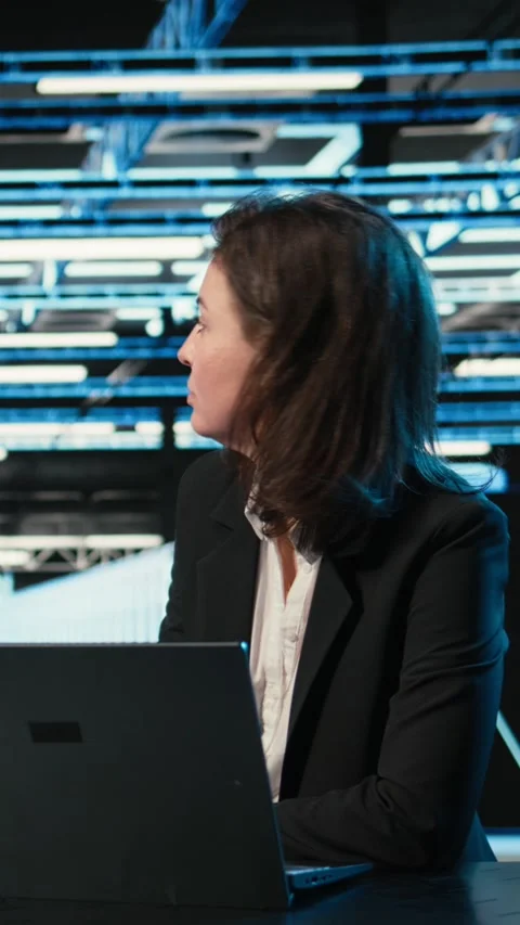 Vertical video Typing on keyboard, laptop and engineer in data center Stock Footage 329321739