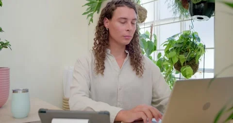 Vertical video: Typing on laptop, worker in light shirt switching to notebook Stock Footage 334843226