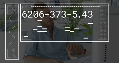 Vertical video: Typing man in blue shirt reading HUD codes with overlay Stock Footage 331198176