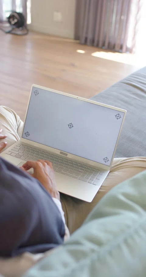 Vertical video: Typing man noticing laptop marker overlays, testing keys on Stock Footage 345130607