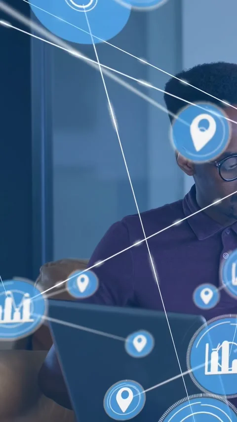 Vertical video: Typing man in polo with specs on sofa, laptop with blue icons Stock Footage 334602498