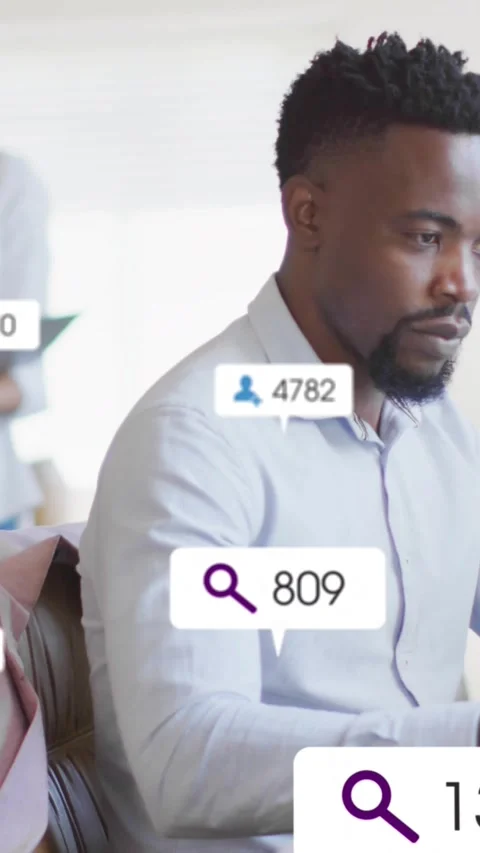 Vertical video: Typing man in shirt responding to updating overlays at computer, Stock Footage 334604965
