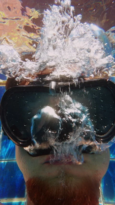 Vertical video. Underwater Close Up Of Man With Diving Mask Blowing Air Bubbles Stock Footage 332297618
