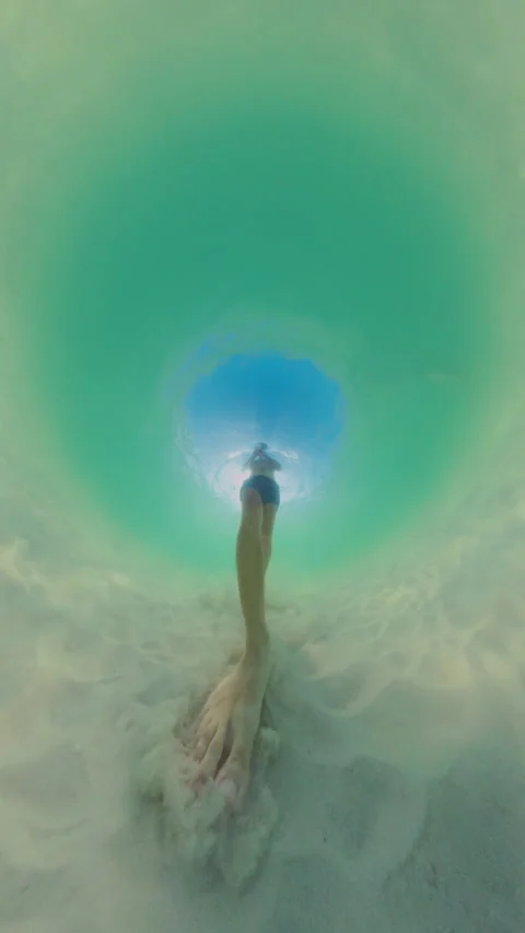 Vertical video. Underwater Wide Angle View Person Walking Away On Sandy Bottom W Stock Footage 333291676