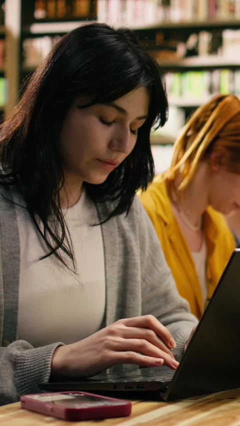 Vertical Video University student getting distracted by notification on phone Stock Footage 336379341
