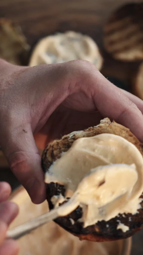 Vertical video of unknown young man preparing burger on wooden board at outdoors Stock Footage 286312450