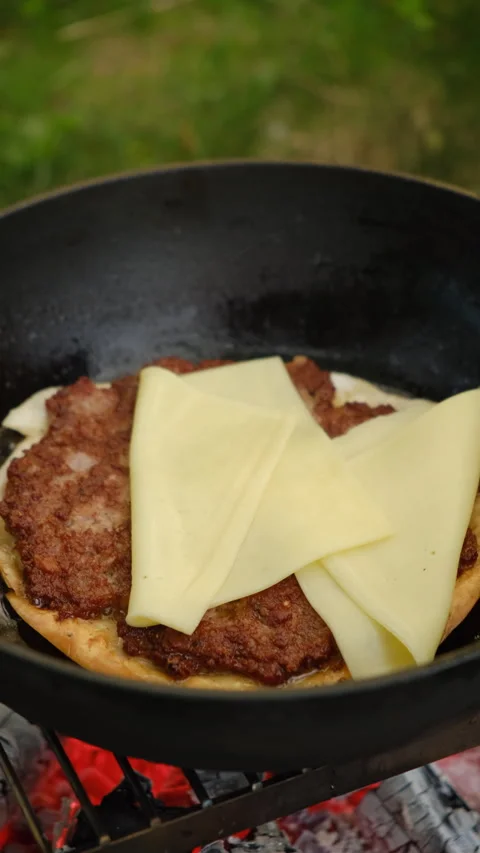 Vertical video of unknown young woman cooking delicious mexican tacos in nature Stock Footage 274250153
