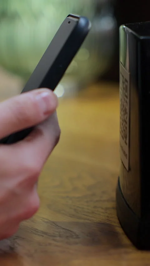 Vertical video. Unrecognizable man scanning QR code on table in restaurant Stock Footage 345240282