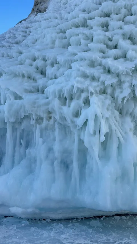 Vertical video of unusual landscape of icy Cape Sagan-Khushun on Baikal Lake Stock Footage 305462453