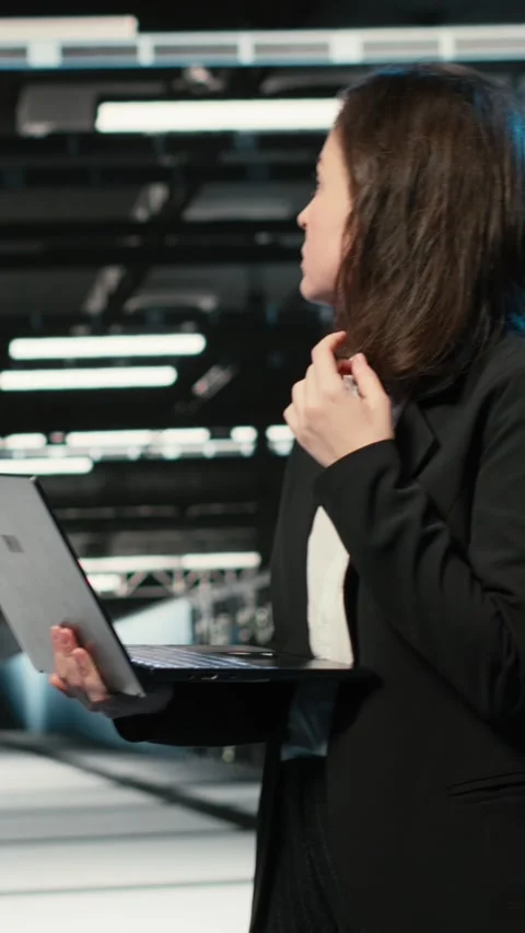 Vertical video Upset data center female technician struggling to make AI Stock Footage 329319252