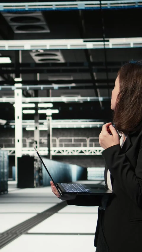 Vertical video Upset data center female technician struggling to make AI Stock Footage 329320235