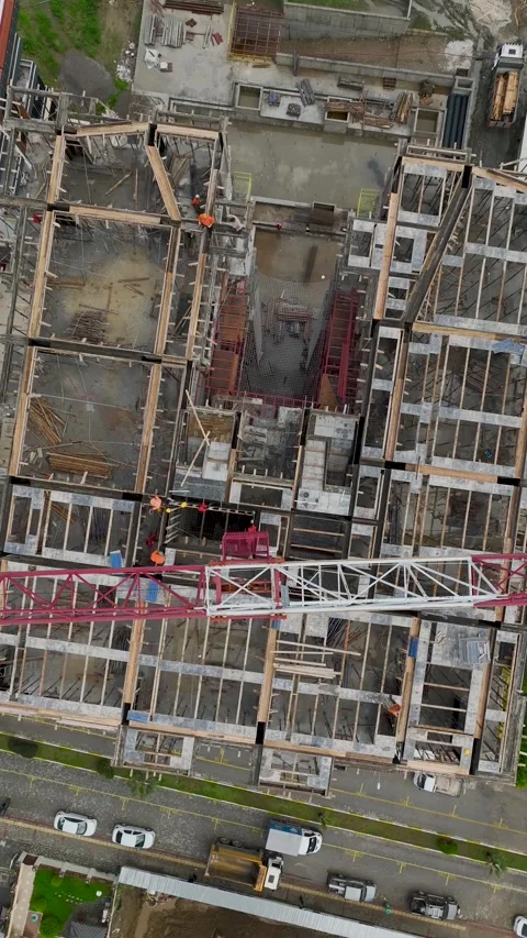 Vertical Video of Urban Tower Structure Rising With Worker Team Stock Footage 342420632