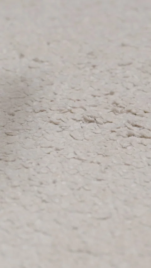 Vertical video. A used condom falls onto a white carpet, illustrating improper Stock Footage 301171462