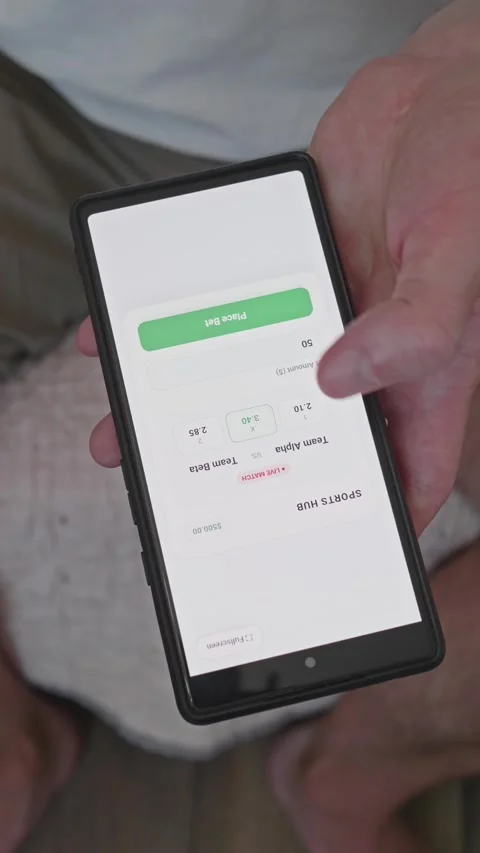 Vertical video of user making an online sports bet on smartphone from odds Stock Footage 341860786