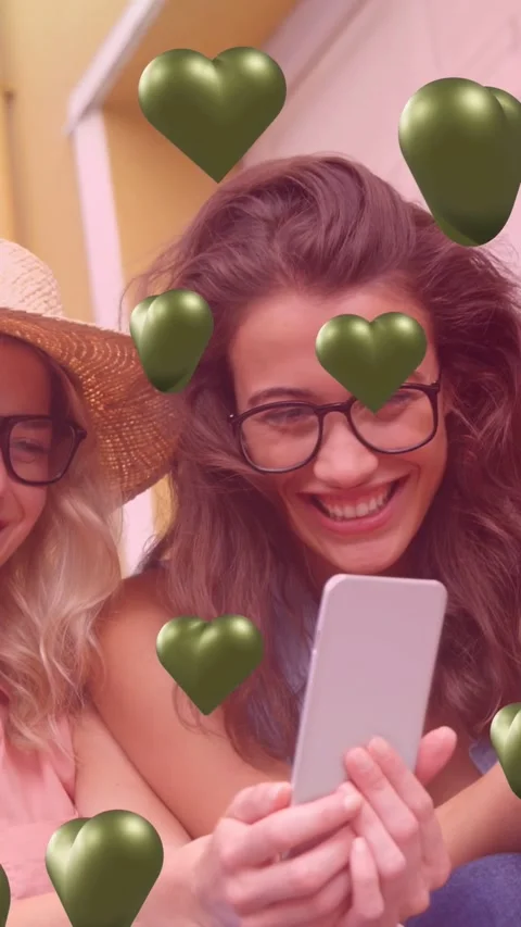 Vertical video: User with specs tapping phone sparking 3D hearts friend leaning Stock Footage 334378825