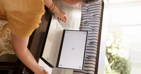 Vertical video: Using laptop, woman working from home at table with notebook Stock Footage 299532743