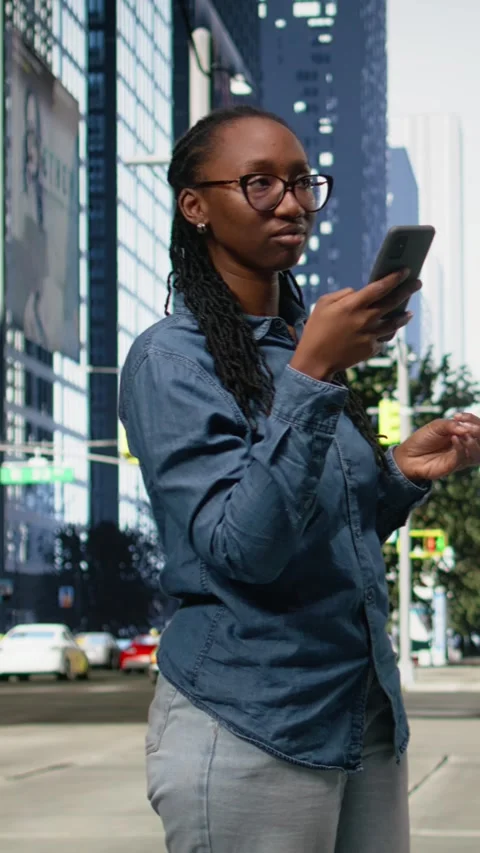 Vertical Video Using navigation app on smartphone, black woman walking around Stock Footage 334199388