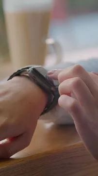 Vertical video. Using smartwatch touchscreen device. Closeup. Person making g Stock Photos