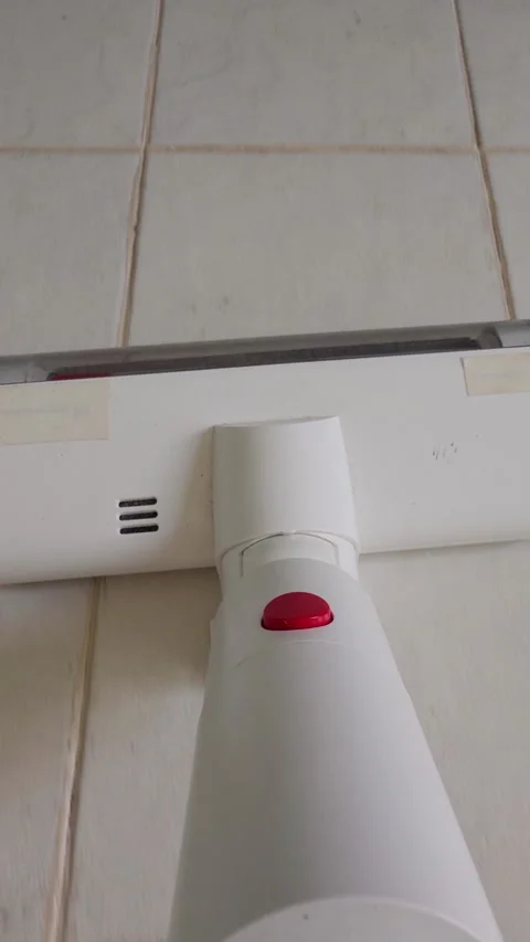 Vertical video. Vacuum Cleaner Head On Light Tile Floor First Person View Cleani Stock Footage 331154401