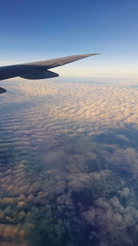 Vertical video. Vast Cloud Ocean Beneath Deep Blue Sky During High Altitude Jour Stock Footage 337151186