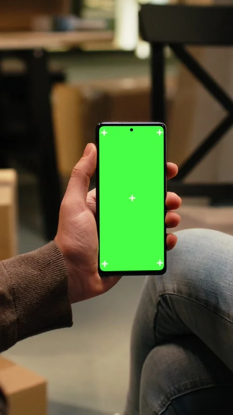 Vertical Video Vertical chroma key on mobile phone with people unpacking Stock Footage 343350210