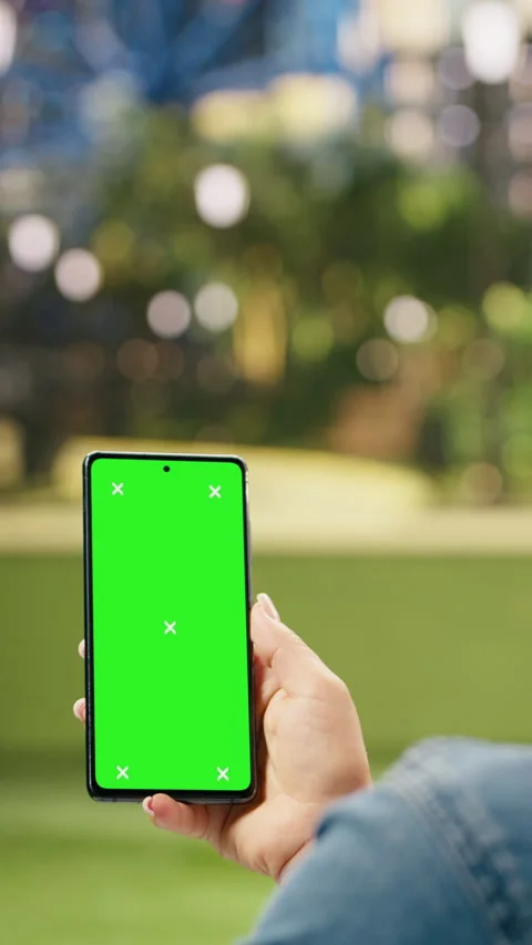 Vertical Video Vertical chroma key mockup on smartphone held by casual woman in Stock Footage 344380039