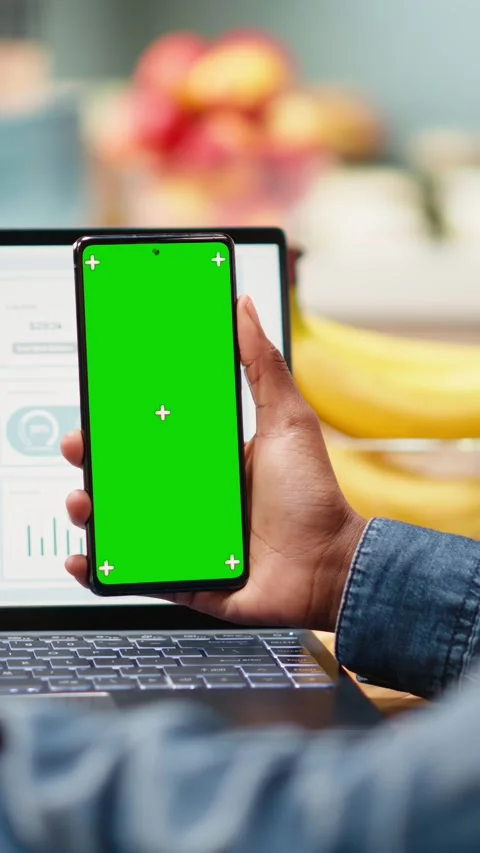 Vertical Video Vertical chroma key screen on smartphone used at home in kitchen Stock Footage 344531233
