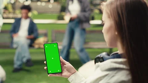 Vertical Video Vertical green screen phone mockup held close to camera in Stock Footage 340802709