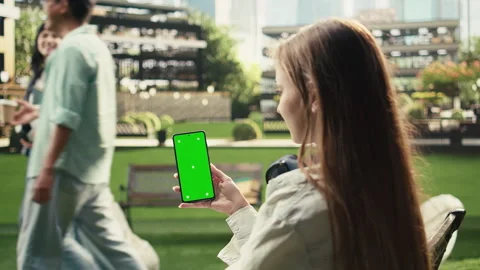 Vertical Video Vertical green screen phone mockup held close to camera in Stock Footage 340809862