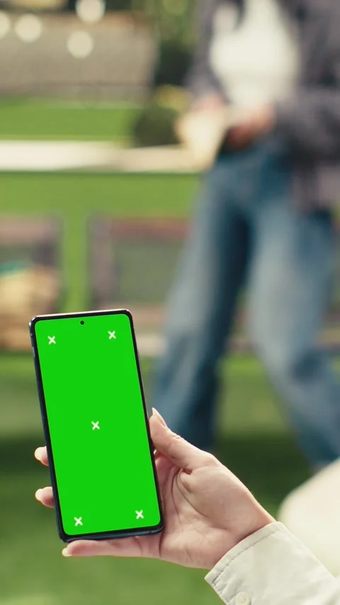 Vertical Video Vertical green screen phone mockup held close to camera in Stock Footage 341316840