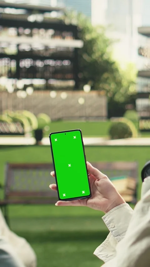 Vertical Video Vertical green screen phone mockup held close to camera in Stock Footage 341317261