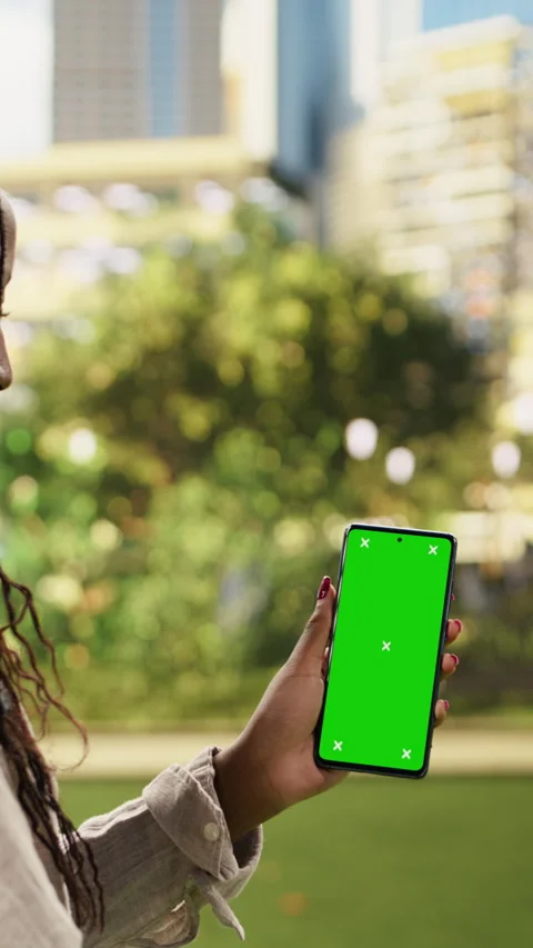 Vertical Video Vertical green screen smartphone mockup held by delivery courier Stock Footage 344380215