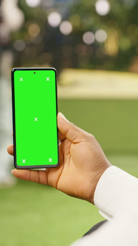 Vertical Video Vertical green screen isolated mockup on smartphone held against Stock Footage 344380237