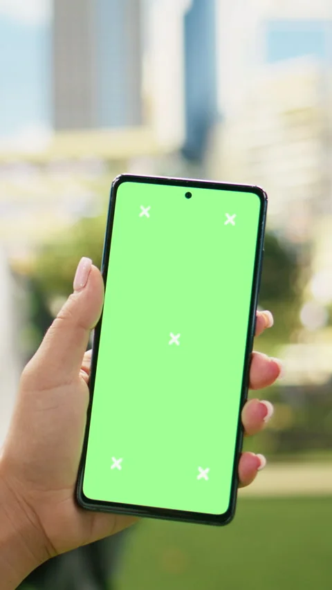 Vertical Video Vertical green screen mockup on phone held by casual woman in Stock Footage 344383811