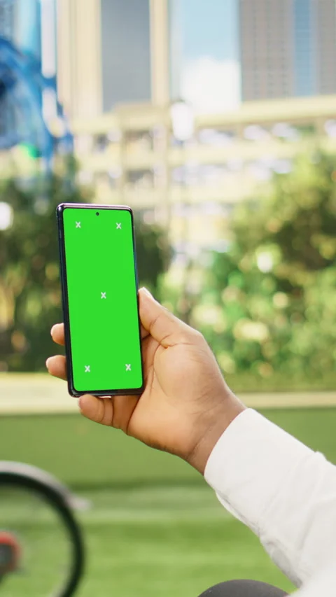 Vertical Video Vertical green screen isolated mockup on smartphone held against Stock Footage 344384092