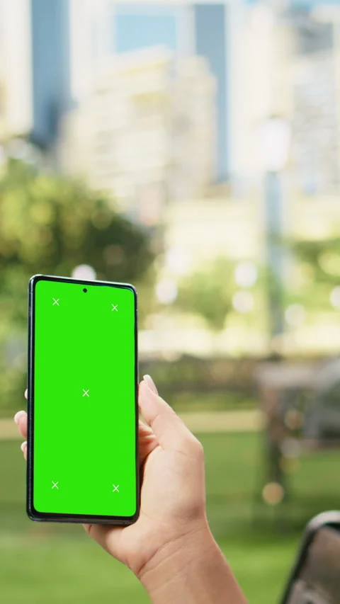 Vertical Video Vertical green screen isolated mockup on smartphone held by woman Stock Footage 344384101