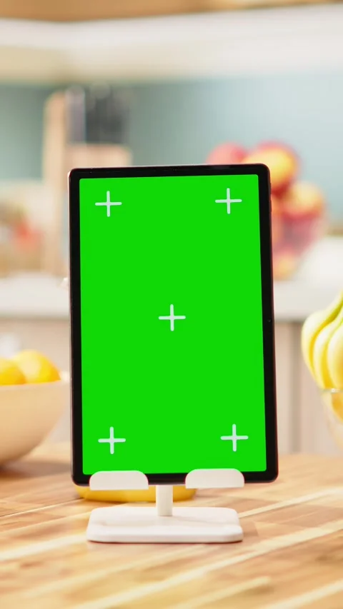 Vertical Video Vertical green screen on tablet with adult working at the kitchen Stock Footage 344531216