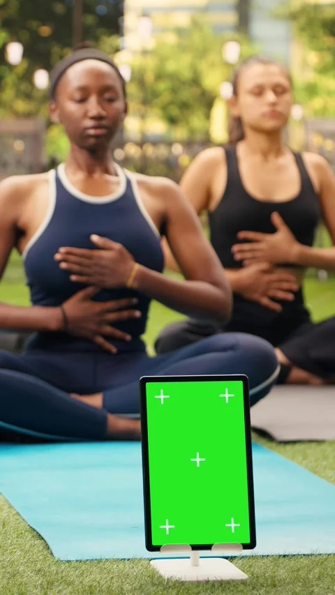 Vertical Video Vertical green screen mockup on tablet near participants doing Stock Footage 346615693