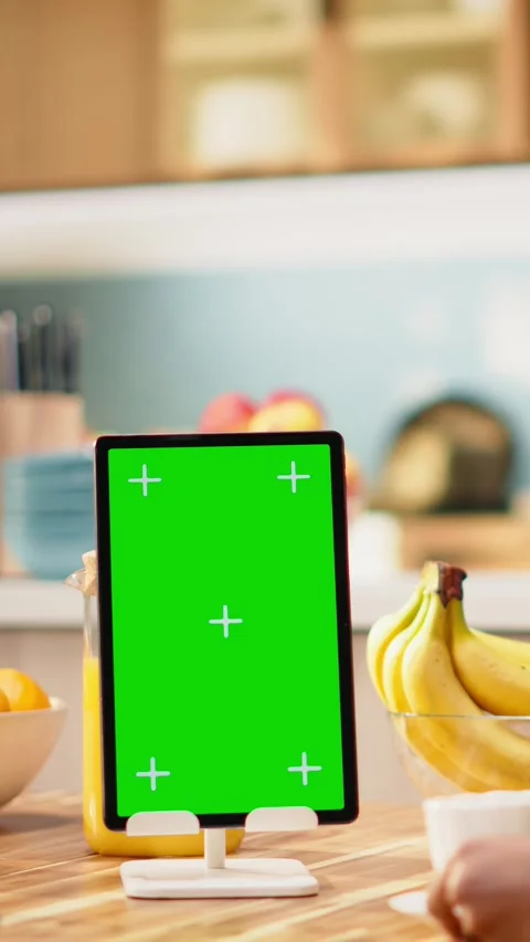 Vertical Video Vertical mockup green screen on tablet in kitchen at wooden table Stock Footage 344531224