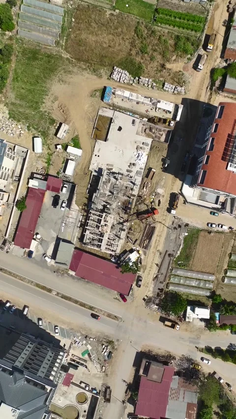Vertical Video: A vibrant construction site as a residential complex takes shape Stock Footage 297662388