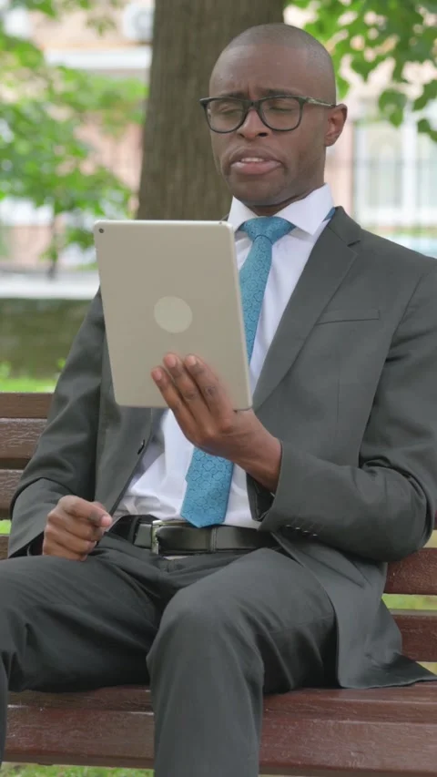 Vertical Video, Video Call on a Tablet by African Businessman Outdoor Video stock 318052280