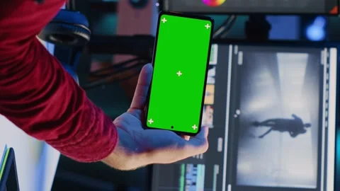 Vertical video Video editor watching tutorial on mockup phone about editing Stock Footage 258802881