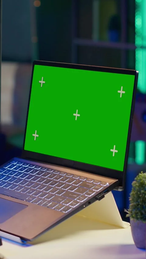 Vertical Video Videographer creating visual effects on montage next to green Stock Footage 319549000