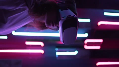 Vertical video - a virtual reality helmet on a woman close-up. Neon light Stock Footage 152693254