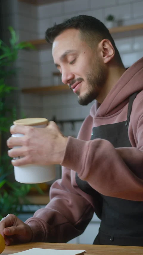 Vertical video. Vlogger man in an apron talking into tablet computer webcam.. Stock Footage 264084264