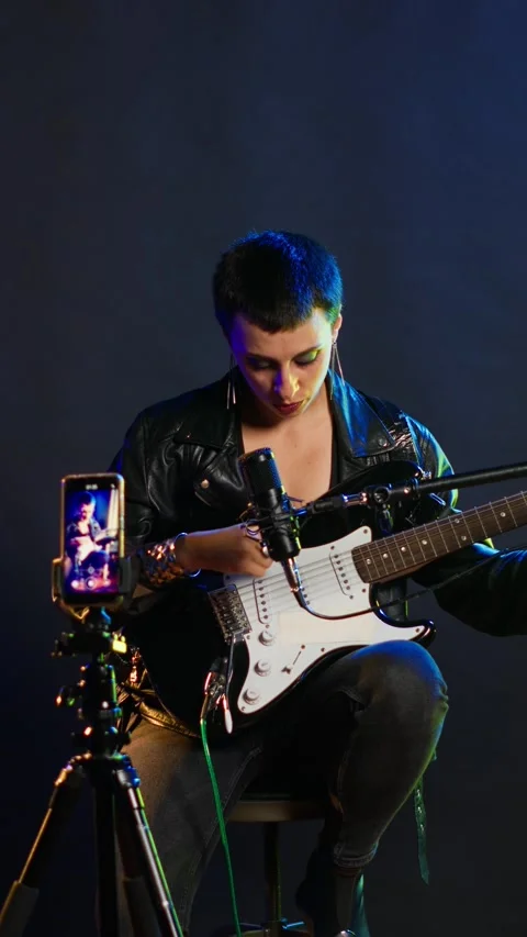 Vertical video Voice training instructor teaching people to play the guitar on Video stock 309011963
