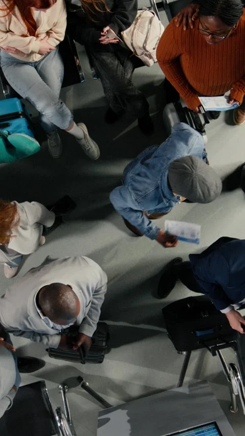 Vertical video Waiting, top down view and people in airport checking flight Stock Footage 334850723