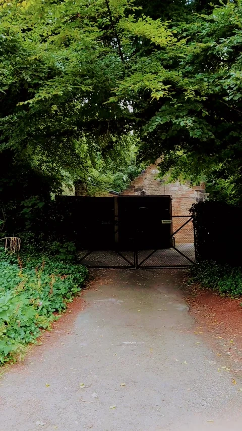 Vertical Video. Walking towards a gated area. Video stock 160079165