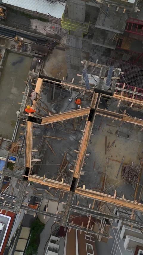 Vertical Video of Wall Construction Operation on Upper Floors Stock Footage 342407808