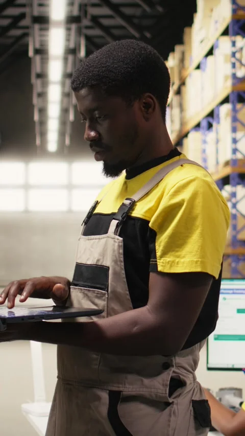 Vertical Video Warehouse clerk inspecting boxes details on shelving units in Stock Footage 315191252